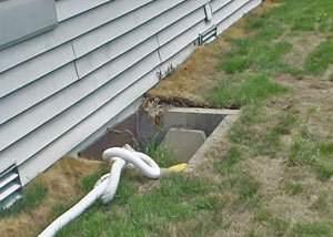 old concrete window well of a Laval crawl space