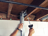Straightening a foundation wall with the PowerBrace™ i-beam system in a Repentigny home.